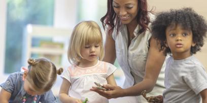 an adult woman with three young children