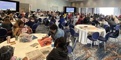 Photo of attendees working at tables