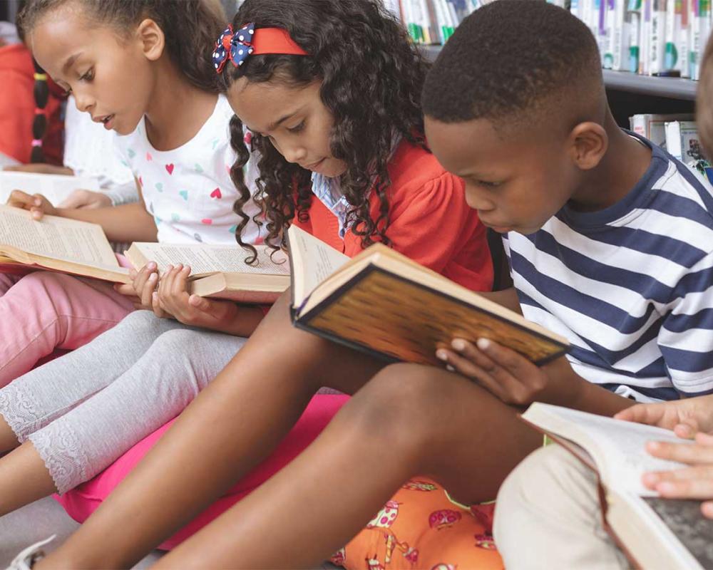 Photo of children reading books together