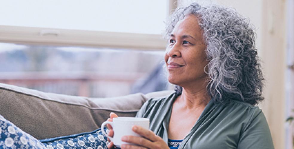 older person with coffee cup